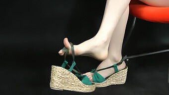 A Zoomed-In View Of Asian Feet Adorned In Stylish Wedge Espadrilles